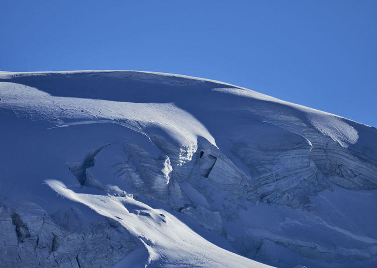 Snowcapped mountain against blue sky