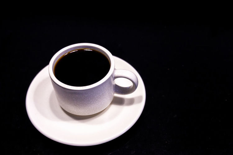 Close-up of coffee cup on black background