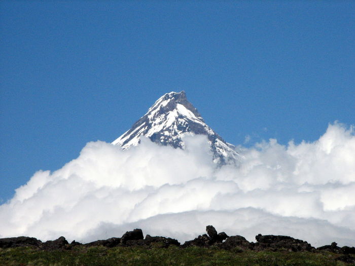 Scenic view of snowcapped mountains against clear blue sky