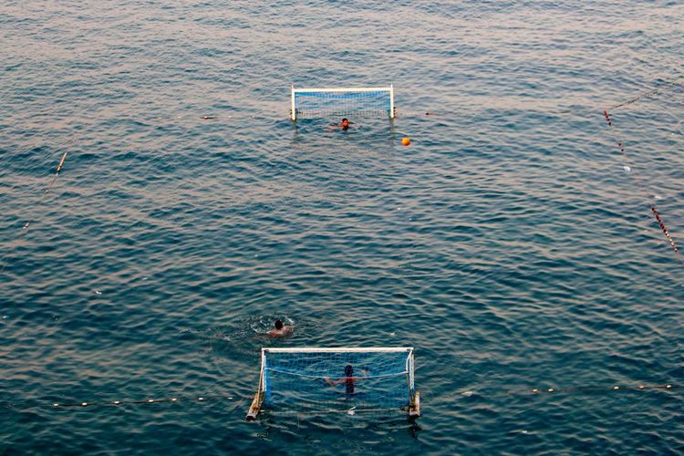 High angle view of people playing water polo at sea