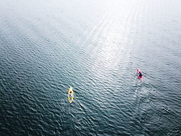 High angle view of people kayaking on lake