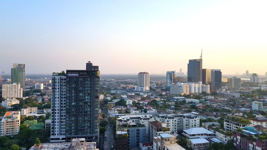 Modern buildings in city against clear sky