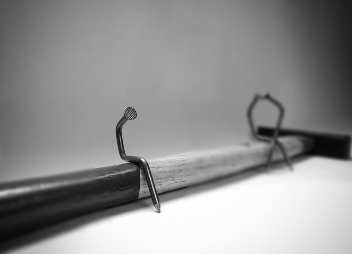Close-up of pen on table against white background