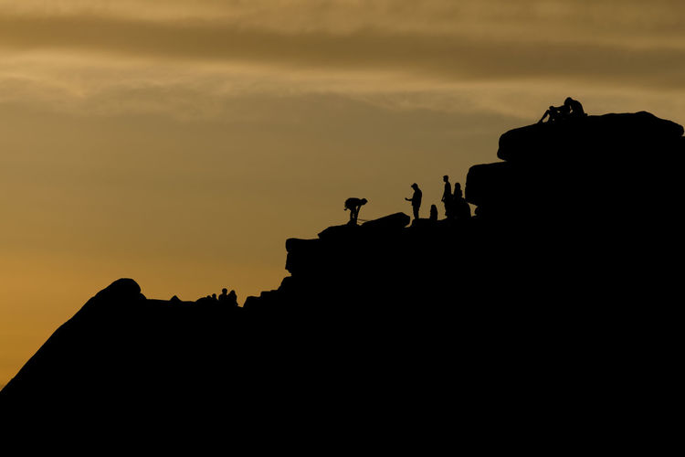 Silhouette people against sky during sunset