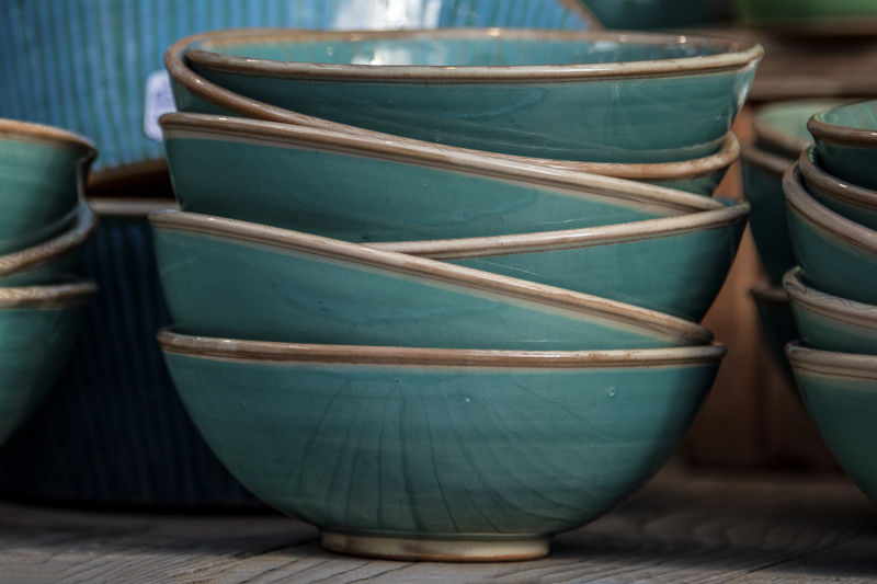 Ceramic bowls in turquoise color at the street market to sell