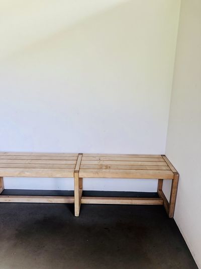 High angle view of bench against wall