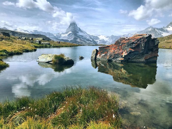 Scenic view of lake and mountains against sky