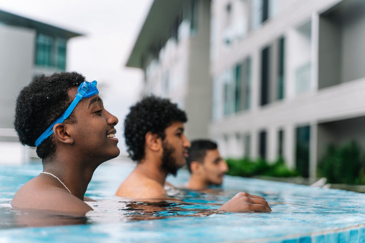 Group of young people of different ethnicities inside a swimming pool