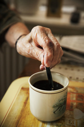 Hands mixing coffee