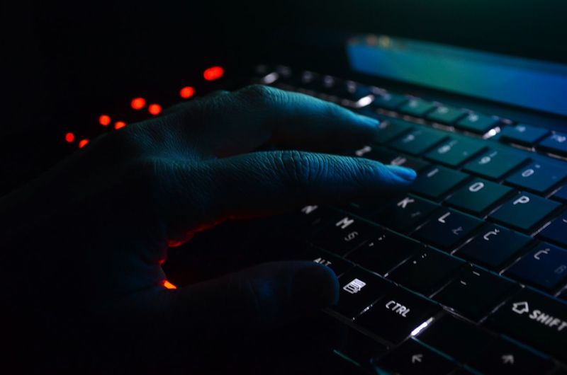CLOSE-UP OF HAND USING LAPTOP