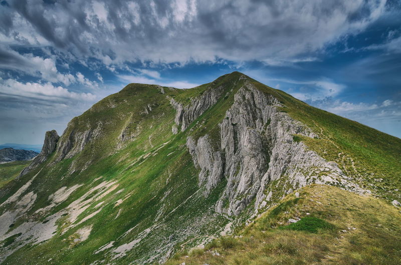 Panoramic view of land and mountains against sky