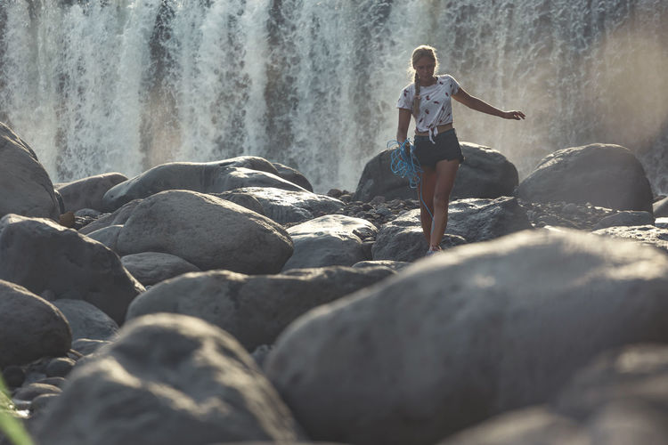 Young woman near waterfall