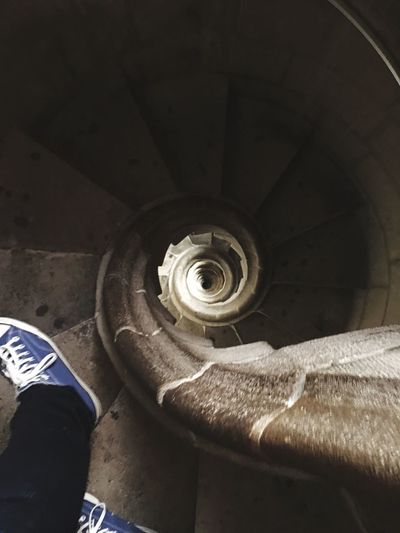 Low section of person on spiral staircase