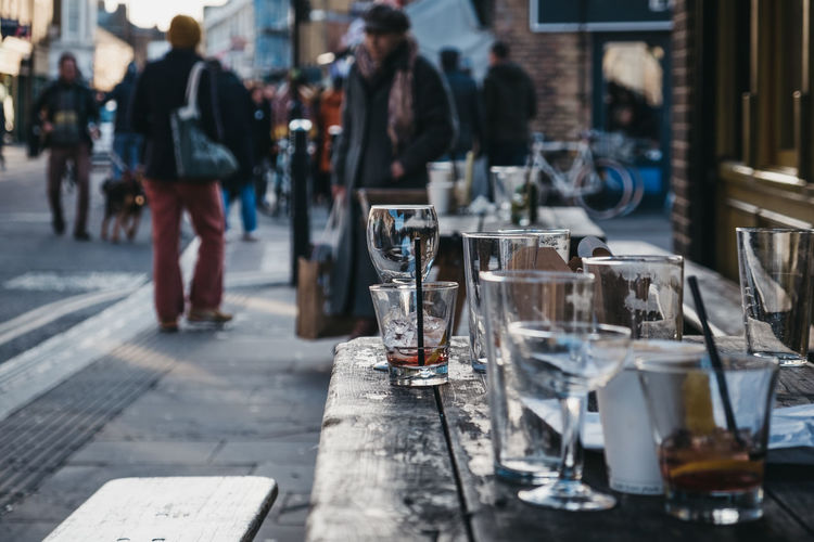 Empty glasses left at an outdoor table of a pub in london, uk.
