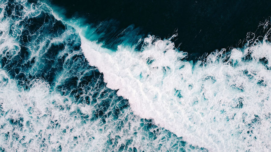 High angle view of waves splashing in sea