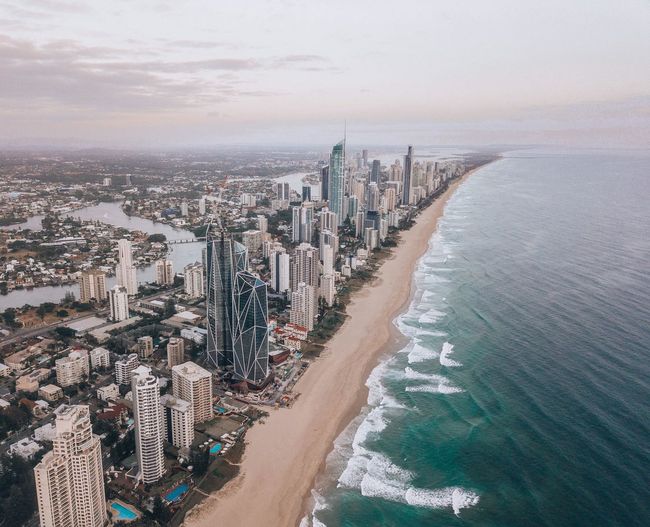 High angle view of buildings against cloudy sky
