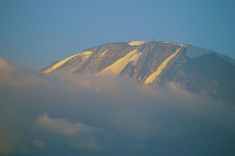 Mount kilimanjaro above the clouds seen from moshi town, tanzania