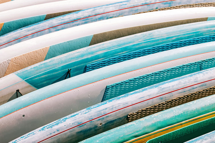 Close-up of colorful paddle boards for rent. summer beach equipment