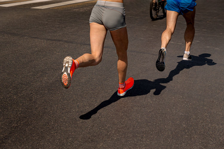 Couple joggers athletes woman and man run in dark road