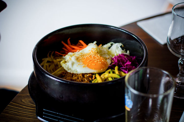 Close-up of bi bim bap served in container on table