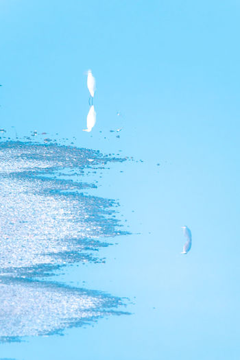 Close-up of bubbles over sea against clear blue sky