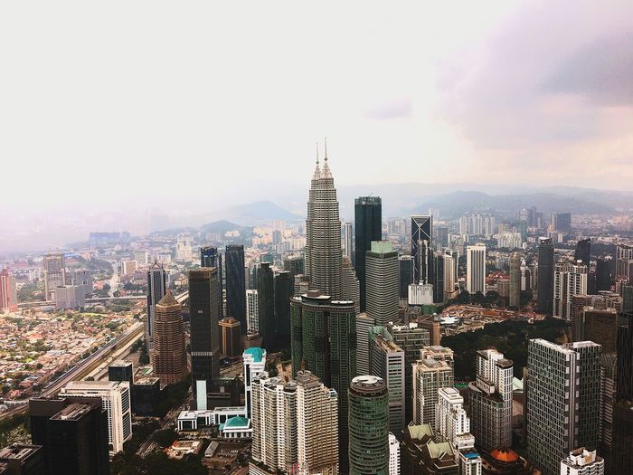 Aerial view of city buildings against sky