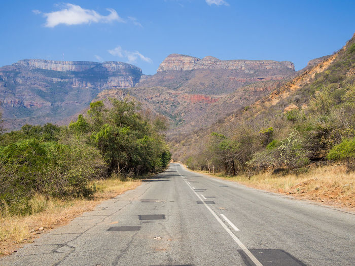 Road passing through drakensberg mountains, south africa