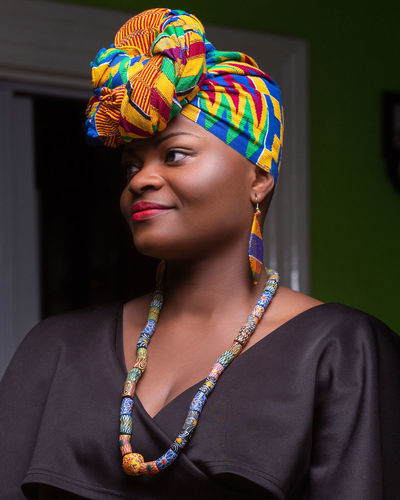 Close-up of thoughtful young woman wearing colorful headscarf