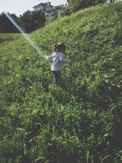 Rear view of a child on field