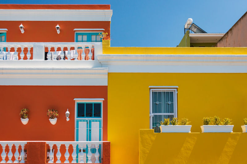 Colorful facades of old houses in orange and yellow, bo kaap malay quarter, cape town, south africa