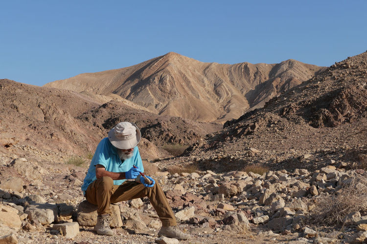 Senior archaeologist at work in the desert 