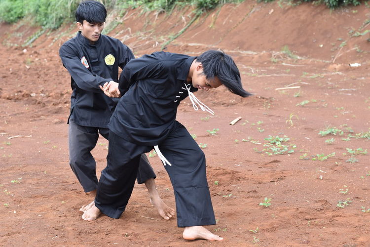 Young men practicing karate outdoors