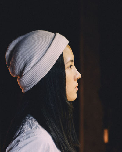 Profile view of young woman wearing knit hat