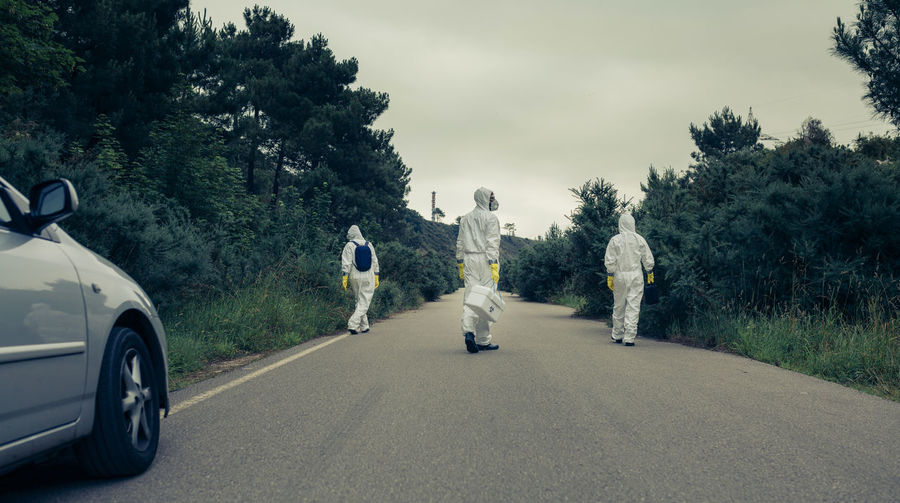 People in workwear walking on road