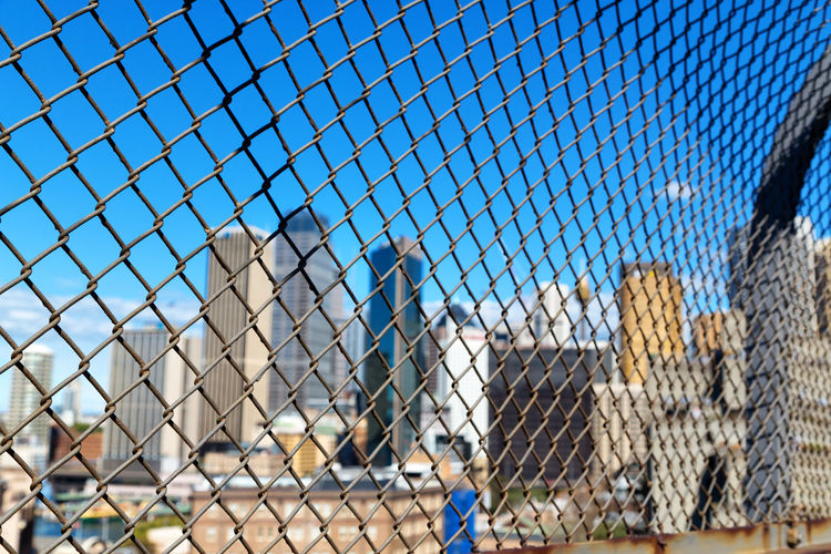 Full frame shot of chainlink fence against building
