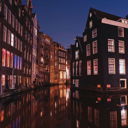 Reflection of buildings in city at night