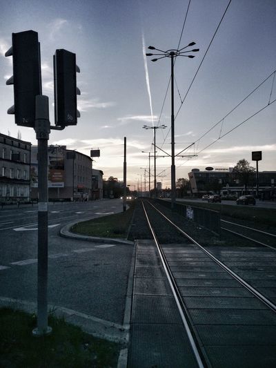 Railroad tracks in city against sky