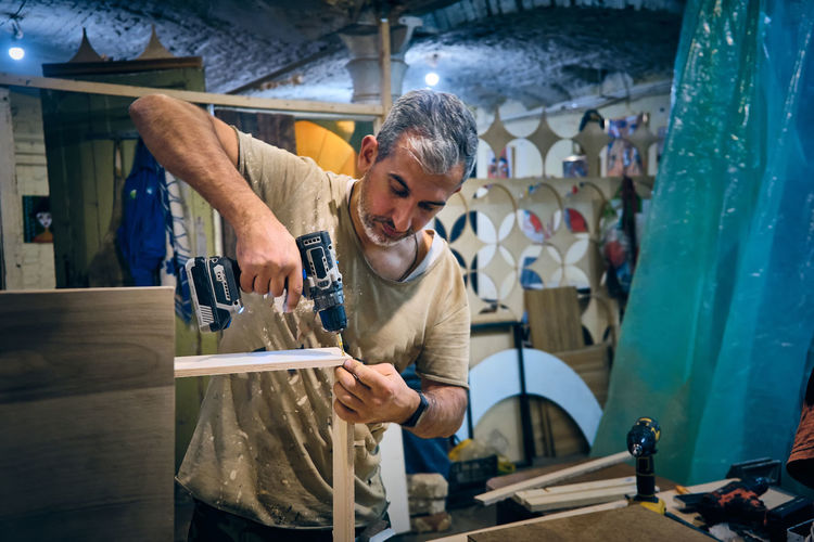 Portrait of man working at workshop