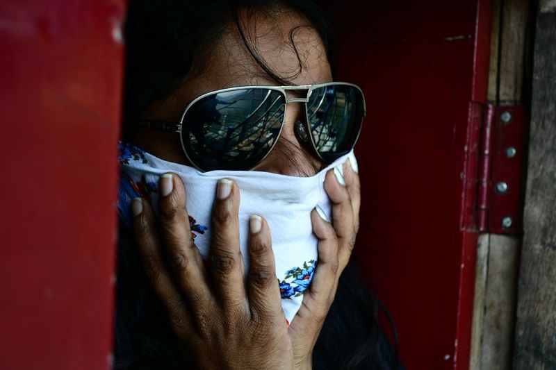 Portrait of man holding sunglasses