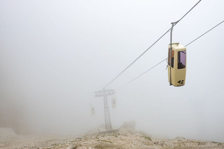 Overhead cable car during foggy weather