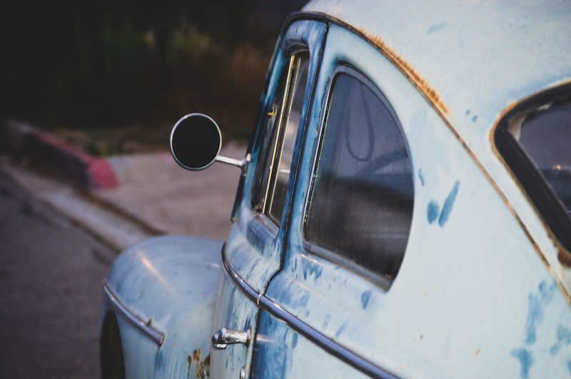Close-up of vintage car on road