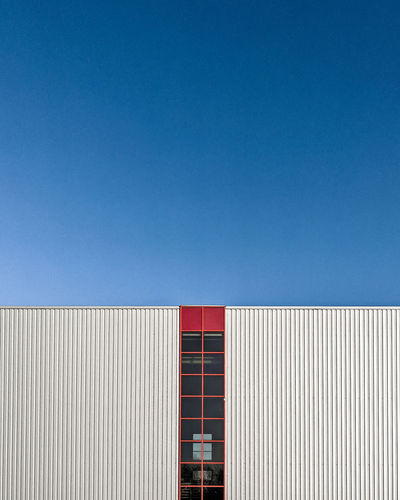 Low angle view of building against clear blue sky