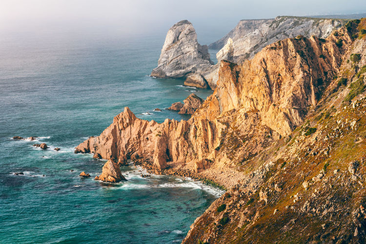 High angle view of rock formation in sea against sky