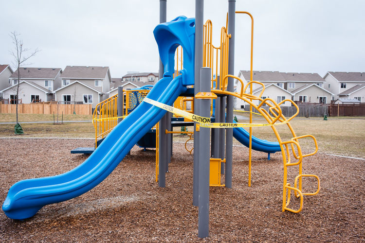 Playground equipment wrapped in caution tape during covid 19 pandemic.