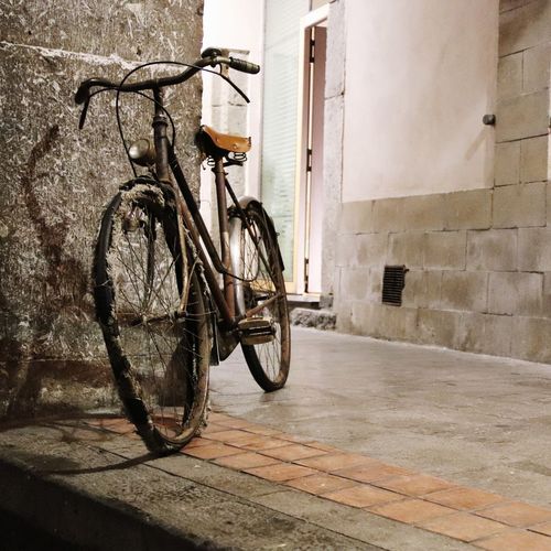 Bicycle leaning on wall