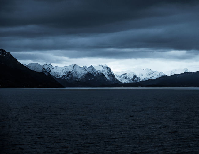 Scenic view of lake and mountains against sky