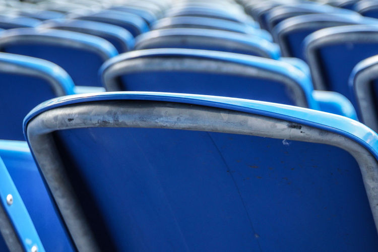 Close-up of blue seats in row