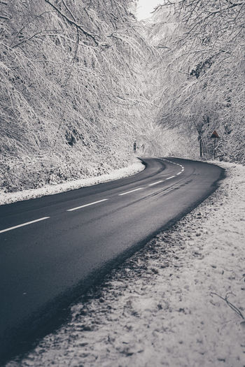 Road by snow covered mountain