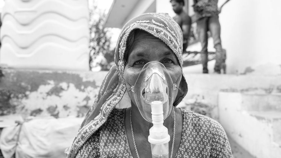 20 may 2021- reengus, sikar, india. old indian woman infected with covid 19 disease. patient inhalin