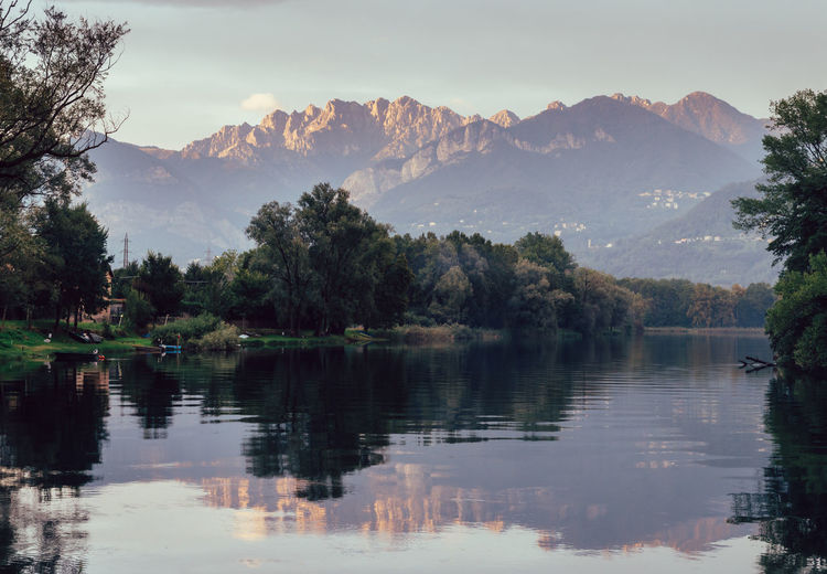 Scenic view of lake and mountains against sky in northern italy